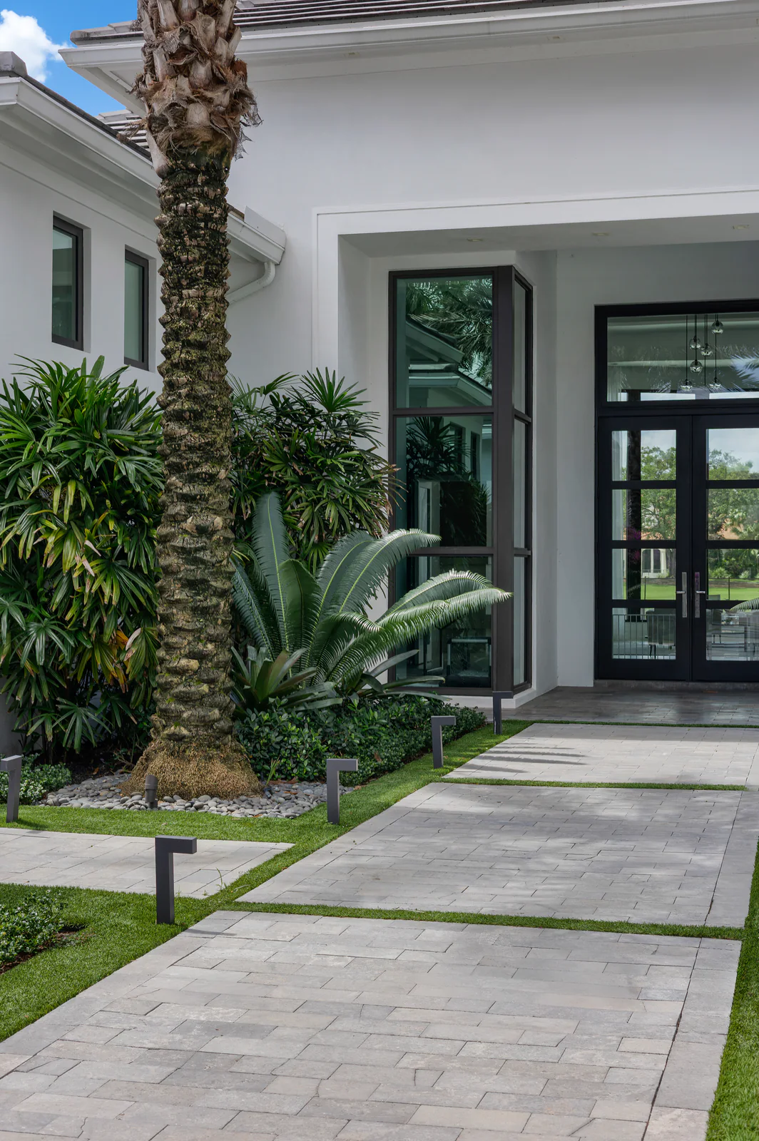 Palm and agave at the entry, by Power Group Care in Palm Beach County