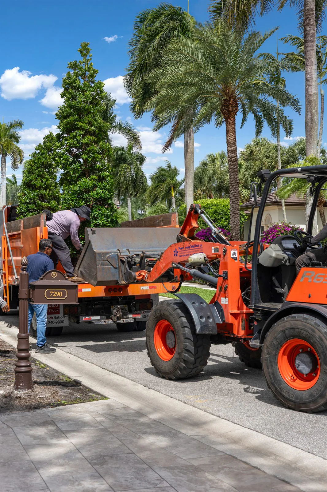 Crew and loader on site, by Power Group Care in Palm Beach County